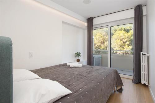 a bedroom with a bed and a large window at Close to Monaco - Amazing Bay View - Free Parking in Saint-Antoine