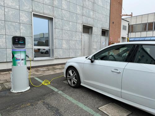a white car is plugged into a parking meter at Euro Hotel in Imola