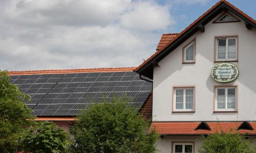 a building with solar panels on the roof at Landhaus Rhönblick in Künzell