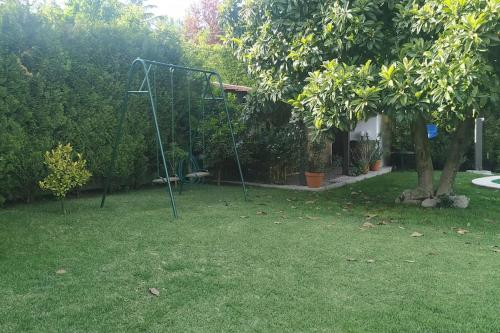 a man sitting on a swing in a yard at Casa de Marlães in Lousada