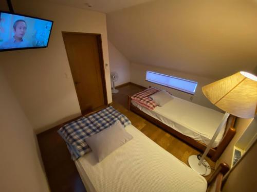 下関市にあるwhite house - Vacation STAY 60636vのベッド2台、薄型テレビが備わる小さな客室です。