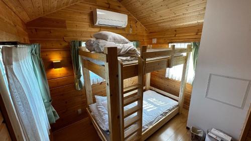a room with two bunk beds in a cabin at Asahikawa City - Camp - Vacation STAY 62748v in Chikabumichō