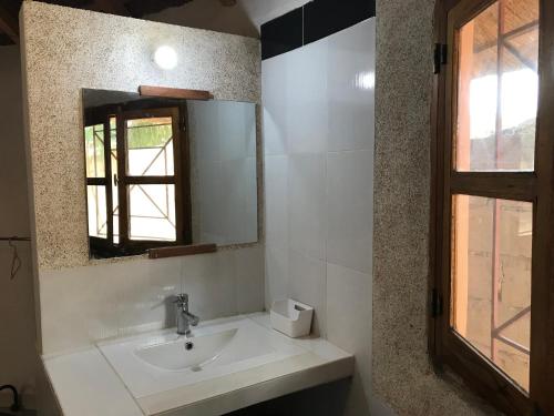 a bathroom with a sink and a mirror at Les Filaos-Case Typique Sénégalaise in Djifère