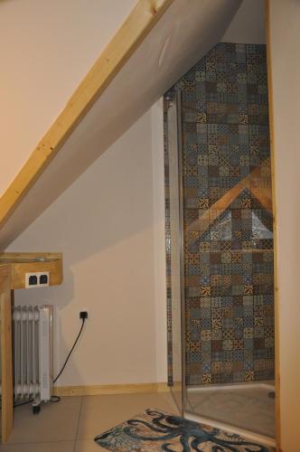 a glass shower in a room under a staircase at Cataleya Rajcza in Rajcza