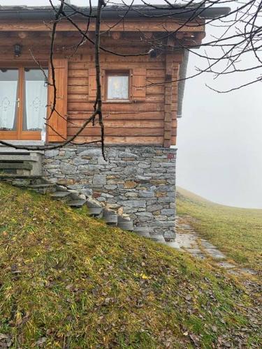 a log cabin on a hill with a window at Rustico Valgrazia in Molare