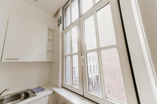 a kitchen with a window and a sink at Cathedral view apartment in Antwerp