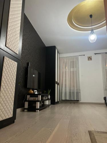 a living room with a flat screen tv on a wall at Apartament Starówka in Nowy Sącz