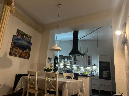 a kitchen with a table and chairs and a window at Apartament Starówka in Nowy Sącz