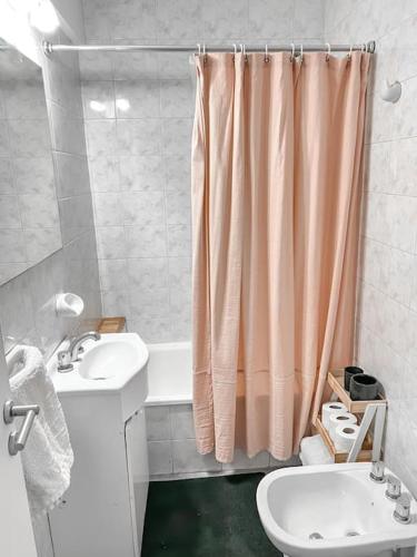 a bathroom with a sink and a shower curtain at Apartamento en Belgrano in Buenos Aires