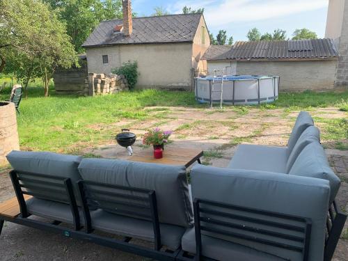 a couch and a table in a yard at Hazmarmar in Csernely