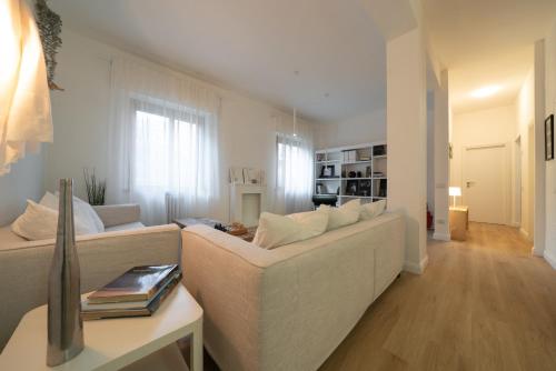 a living room with a white couch and a table at 12 living in Ancona