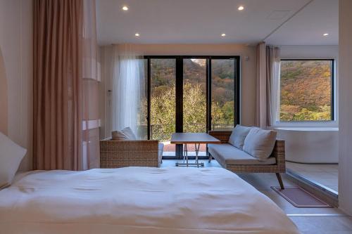 a bedroom with a bed and a couch and a table at R;MOGAMI - Vacation STAY 25467v 