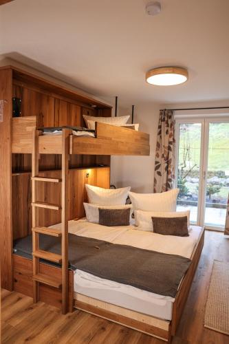 a bedroom with a bunk bed with a ladder at Ferienwohnung Söldenköpfl-Blick in Schönau am Königssee