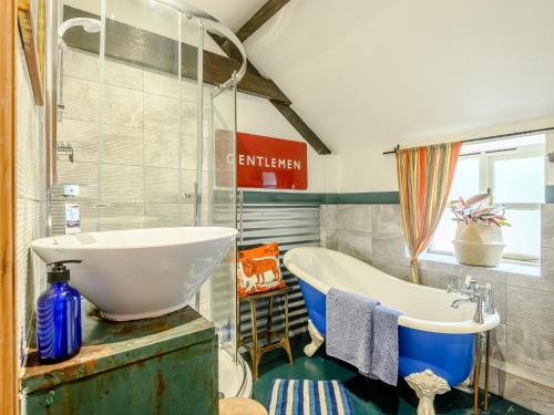 a bathroom with a tub and a sink at 2 Bed in Frome 89168 in Holcombe