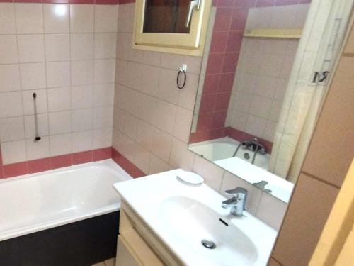 a bathroom with a sink and a tub and a mirror at Appartement Briançon, 2 pièces, 6 personnes - FR-1-762-52 in Briançon