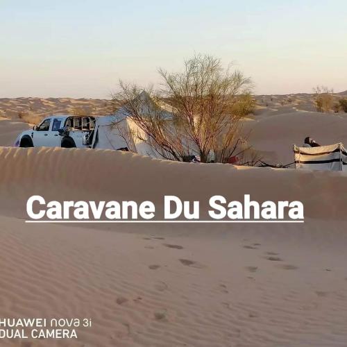 a truck parked in the sand in the desert at Private Camp25km-from DOUZ in Douz