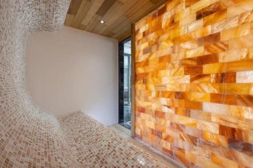 a room with a brick wall and a window at Harmonija SPA RESORT in Vrdnik