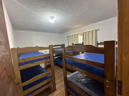 a room with three bunk beds in a room at Rancho NPI in Guarulhos