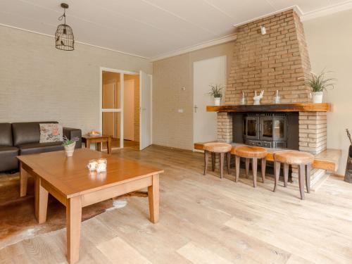 a living room with a table and a fireplace at Holiday home in De Bult near Giethoorn Waters in De Bult