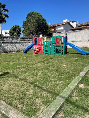 a group of playground equipment in a yard at Apartamento confortável Ilhéus in Ilhéus