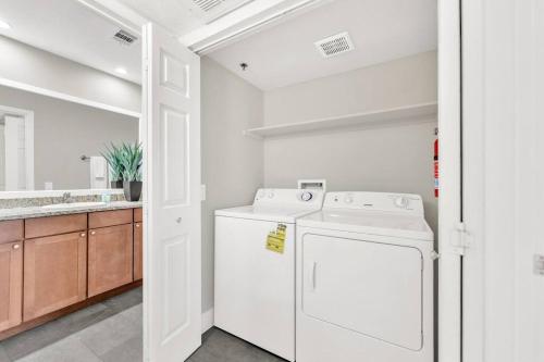 a white laundry room with a washer and dryer at Trinity Suite 2b 2b Strip View in Las Vegas