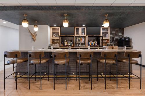 a bar in a restaurant with stools at a counter at The Winslow - Winslow, AZ in Winslow