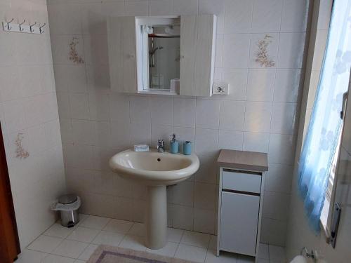 a white bathroom with a sink and a mirror at B&B SunBeach in San Benedetto del Tronto