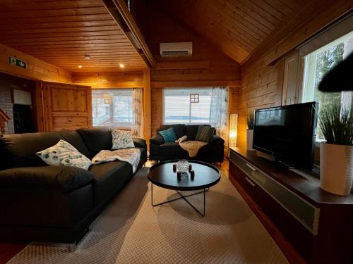 a living room with a couch and a coffee table at Villa Kuusiranta in Ähtäri