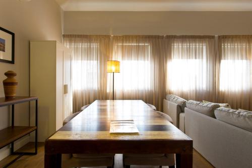 a living room with a wooden table and a couch at RVA - Porto Central Flats in Porto