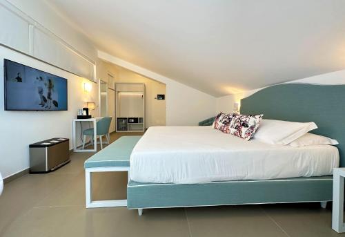 a bedroom with a large bed and a table at Seaside Hotel in Capo dʼOrlando