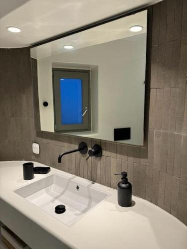a bathroom with a white sink and a mirror at Vivant Naousa Residence 4 in Naousa