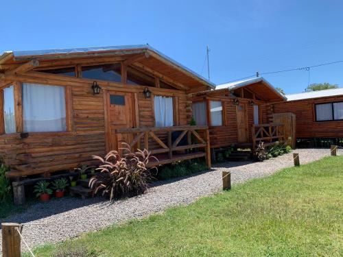 a log cabin with a path leading to it at Cabañas Punta Arena in San Pedro