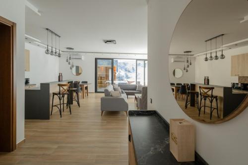 a living room with a mirror on the wall at Harmonija SPA RESORT in Vrdnik