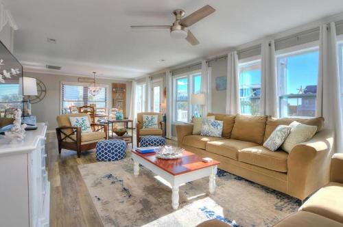 a living room with a couch and a table at A-Frameable Moment in Oak Island