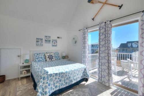 a bedroom with a bed and a balcony at A-Frameable Moment in Oak Island