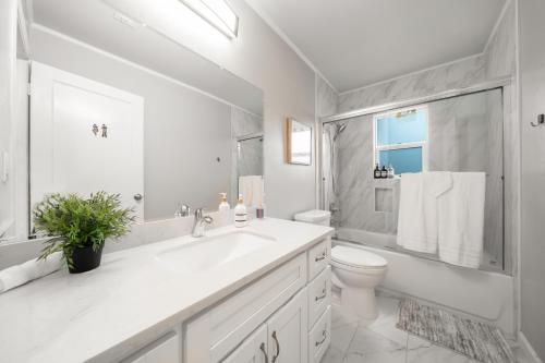 a white bathroom with a sink and a toilet at 4BR Lux Los Gatos Home: Style & Comfy in Los Gatos