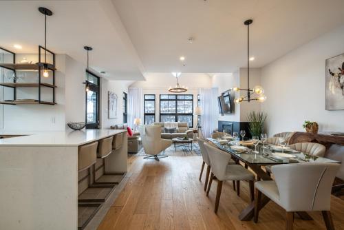 a kitchen and dining room with a table and chairs at Tremblant Prestige - Les Eaux 215-8 in Mont-Tremblant
