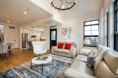 a living room with a couch and a table at Tremblant Prestige - Les Eaux 215-8 in Mont-Tremblant