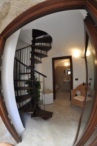 a reflection of a spiral staircase in a mirror at Residenza Lastene in Bovino