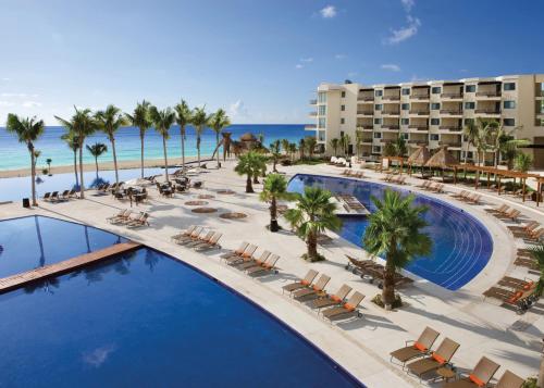 an aerial view of a resort with a pool and palm trees at Dreams Riviera Cancun Resort & Spa - All Inclusive in Puerto Morelos