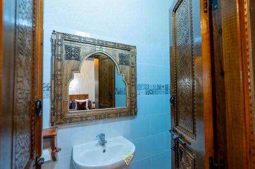 a bathroom with a sink and a mirror at Riad Village in Imlil