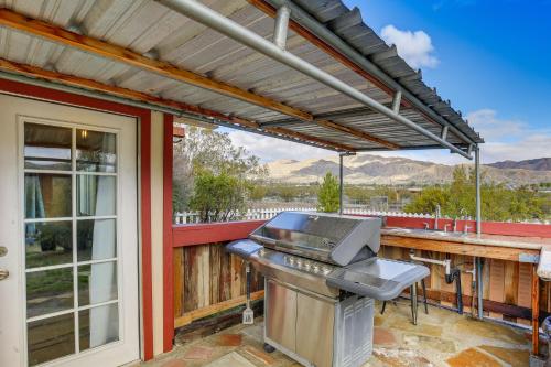 a grill on a patio with a view of the mountains at Outdoor Kitchen Mtn-View Morongo Valley Cabin! in Morongo Valley