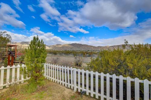 a white fence with a view of the mountains at Outdoor Kitchen Mtn-View Morongo Valley Cabin! in Morongo Valley