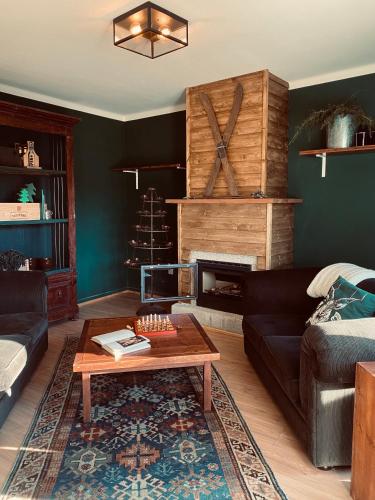 a living room with a couch and a fireplace at Refúgio do Mezio in Mezio