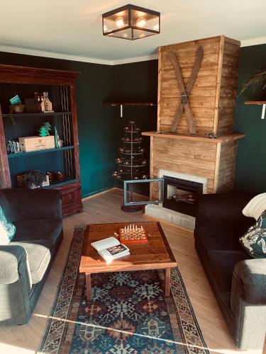 a living room with a table and a fireplace at Refúgio do Mezio in Mezio