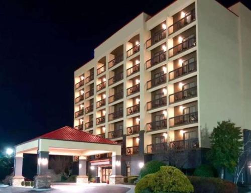 a hotel building with a gazebo in front of it at Vista Suites Near Island and Leconte Convention Center in Pigeon Forge