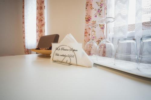 a white counter with glass vases on a shelf at Pension Štěpán in Mikulov
