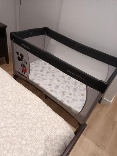 a black and white bunk bed in a room at Apartamento Playa del Con in Moaña
