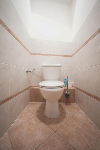 a bathroom with a white toilet in a room at Pension Štěpán in Mikulov
