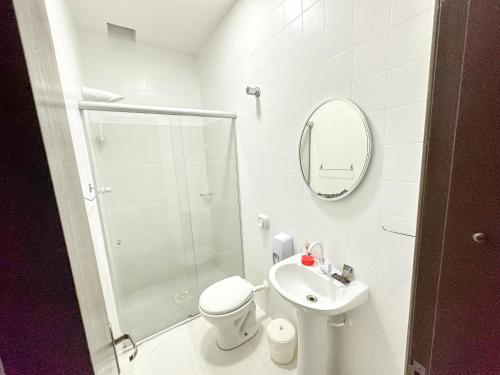 a bathroom with a shower and a toilet and a sink at Presto Hotel in Blumenau